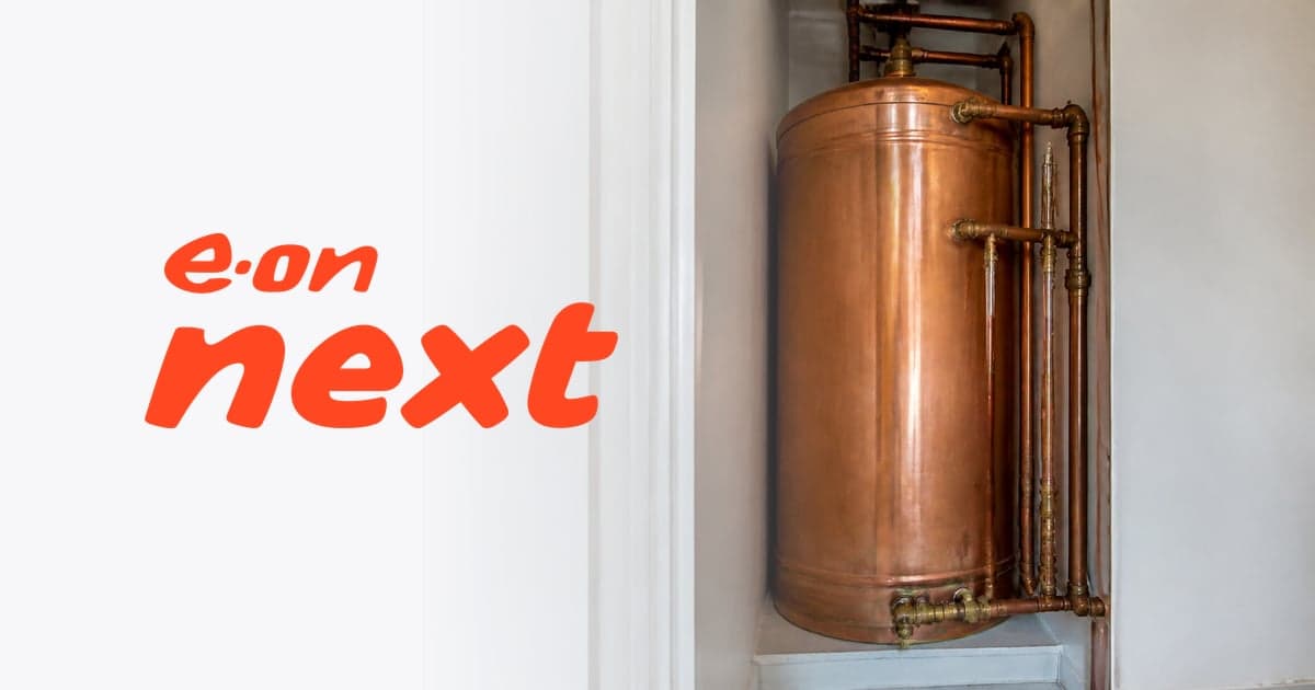 a copper hot water cylinder and its pipework in a narrow airing cupboard