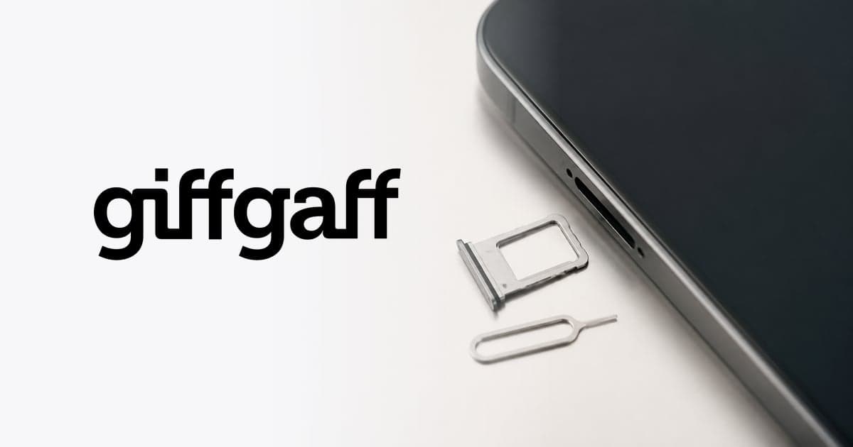 a SIM tray lifted out of the side of a phone with a small metal pin