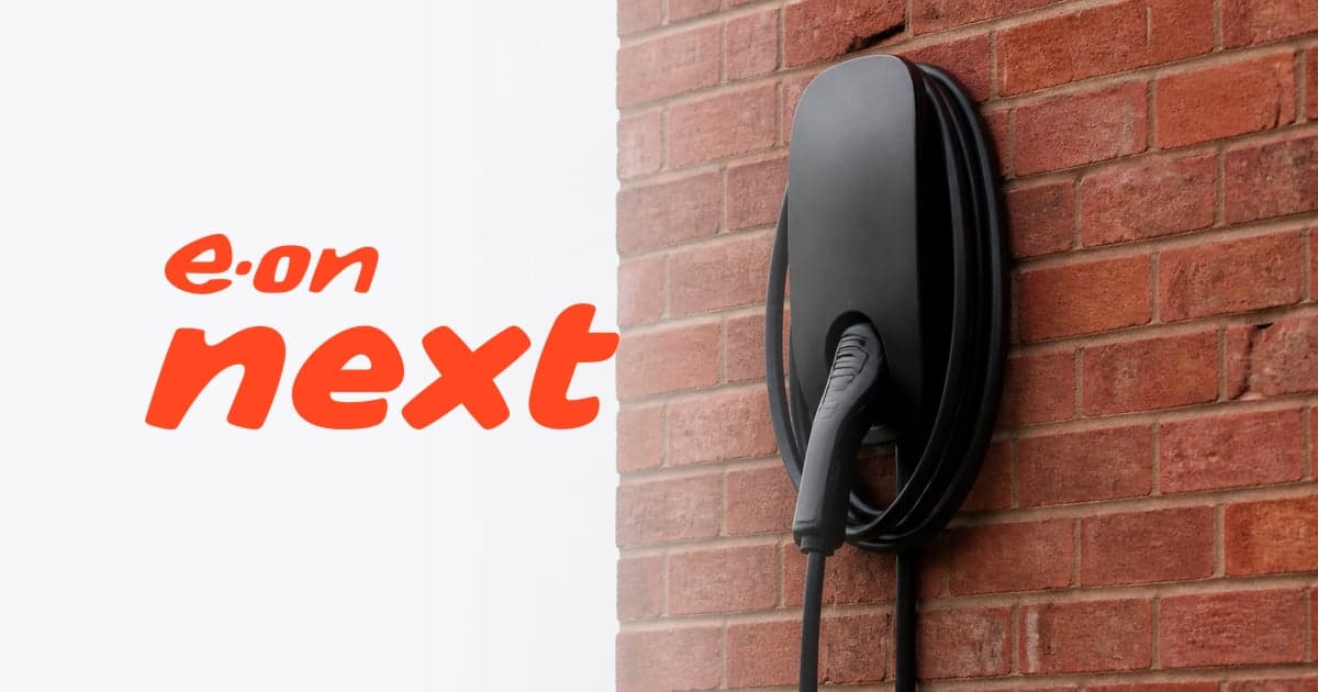 a home charge point on a red brick wall with its cable hooked over it