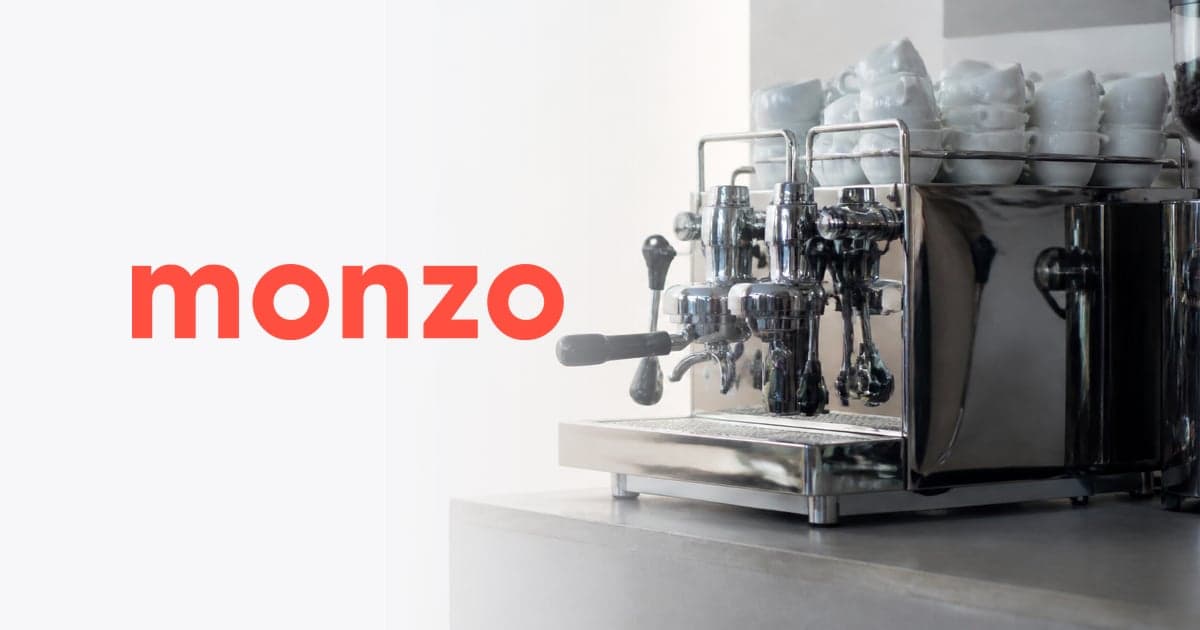 a chrome espresso machine and a stack of clean cups on an independent café counter