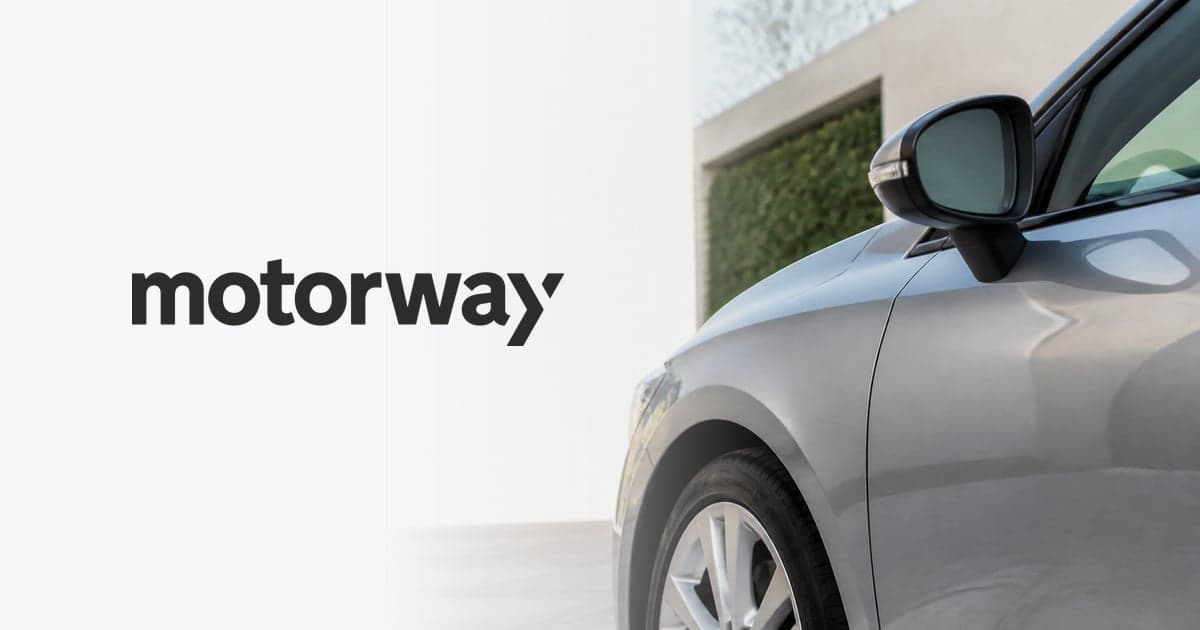 the front wing and wing mirror of a silver hatchback parked on a suburban driveway
