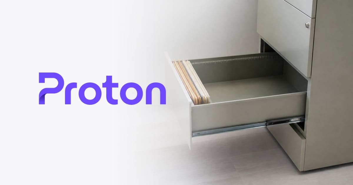 a mostly empty filing drawer pulled open in a bright, uncluttered home office, a few paper folders standing at the front with clear space behind them