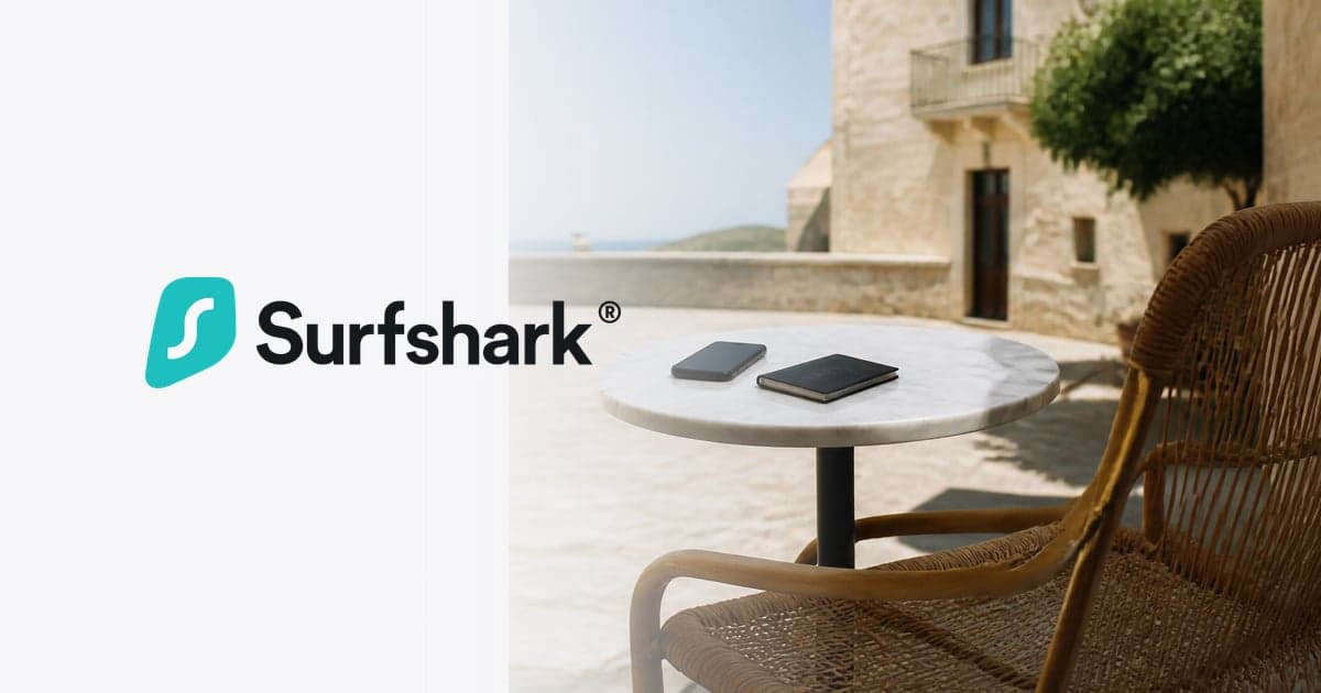 a phone and a passport face down on a small café table in a sunlit Mediterranean square